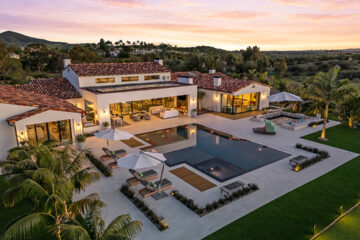 Set on a 2.62-acre lot, this 7,014-square-foot estate on 16786-88 Calle Hermosa in Rancho Santa Fe features 6 bedrooms, 8 bathrooms, a 5-car garage, and a 2-bedroom guest house. It is listed for $9,850,000