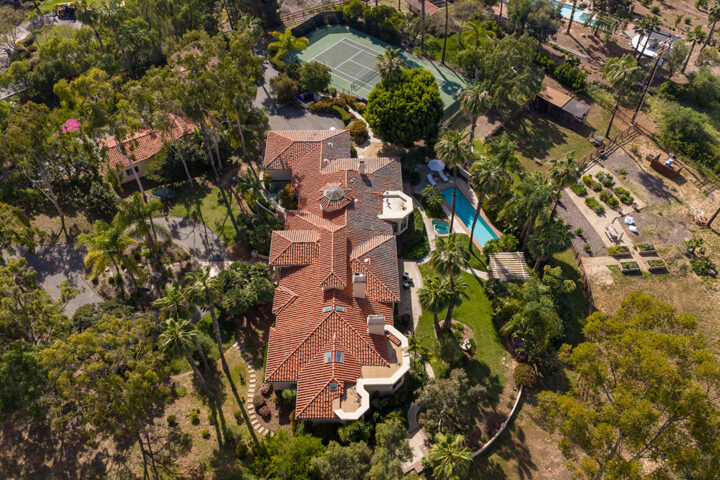 The house features a pool, a cedar-lined dry sauna, Breathe Degrees cold plunge with 36-degree chiller, and redwood enclosed surf shower; listed for $5,500,000, 18044 Loma Alegre in Rancho Santa Fe features equestrian facilities, tennis court, organic garden, a chicken coop, and a private well
