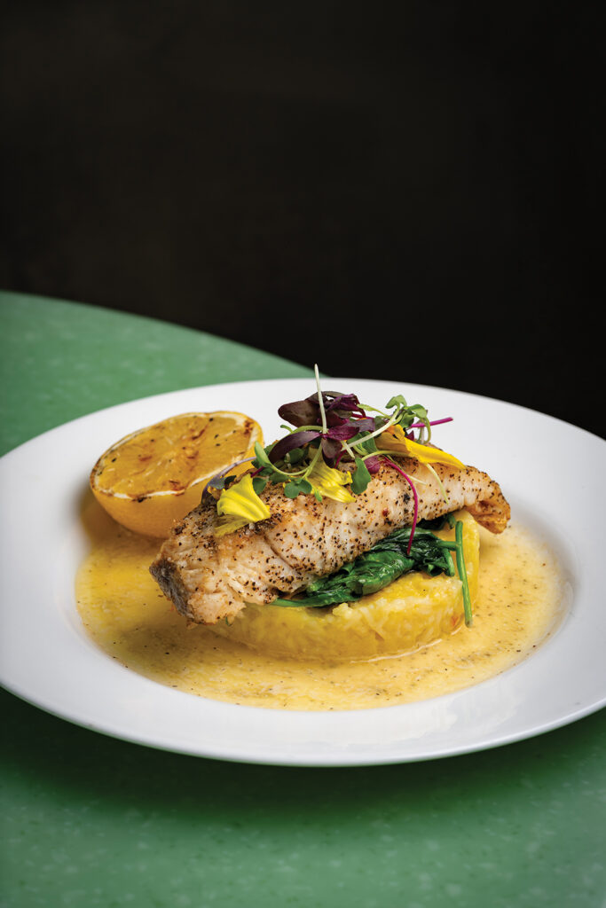 NZ Sea Bass: saffron risotto, sautéed spinach, and beurre blanc sauce