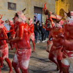 Diablos, or devils, make their way through the streets of Oaxaca while chanting and beating drums