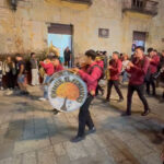 Marching bands play loudly as revelers gather behind them to walk the streets of Oaxaca during Dia de los Muertos celebrations