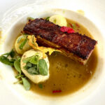 Crispy pork served in a yellow mole sauce at Los Danzantes Restaurant