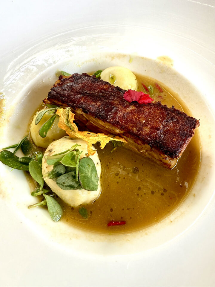 Crispy pork served in a yellow mole sauce at Los Danzantes Restaurant