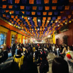 Streets in Oaxaca fill with revelers each night, strolling to music under colorful lights and decor