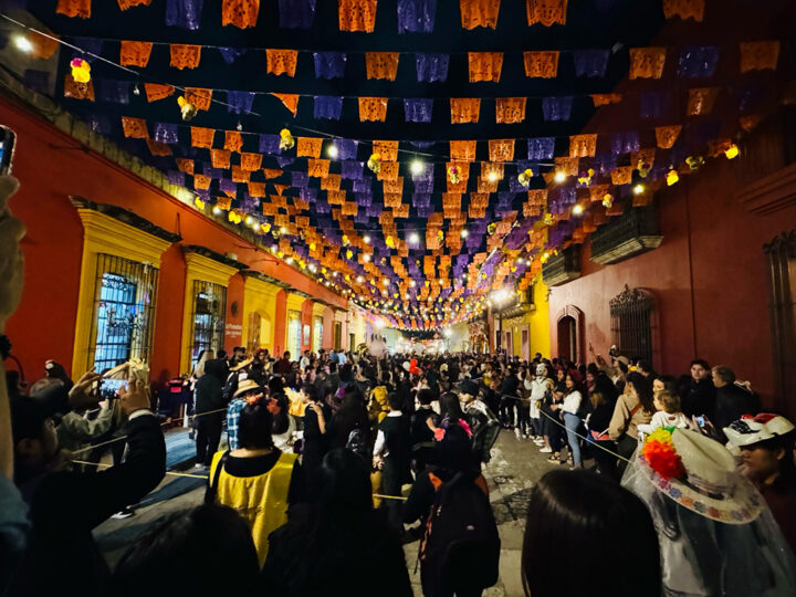 Streets in Oaxaca fill with revelers each night, strolling to music under colorful lights and decor