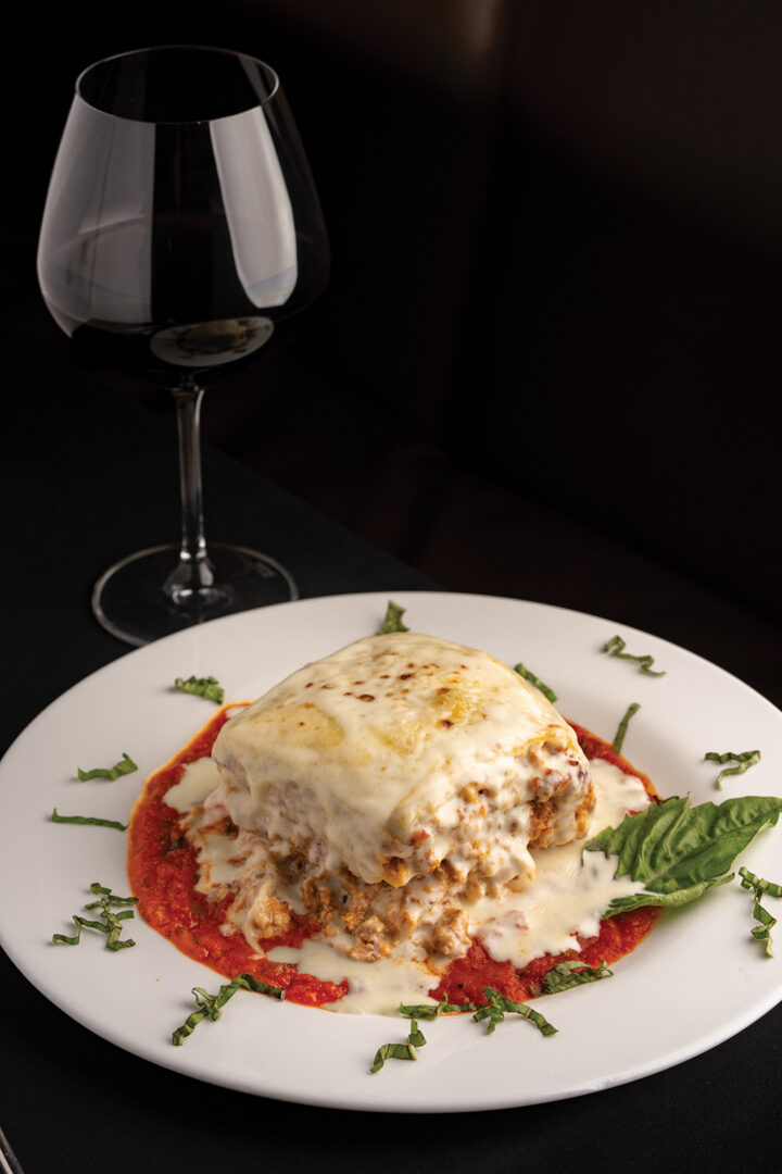 Lasagne Firenze: layered with ricotta cheese, beef, chicken, sausage, roma tomato, mushroom, and parmigiano-reggiano, with marinara sauce and creamy bechamel