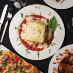 Lasagne Firenze: layered with ricotta cheese, beef, chicken, sausage, roma tomato, mushroom, and parmigiano-reggiano, with marinara sauce and creamy bechamel